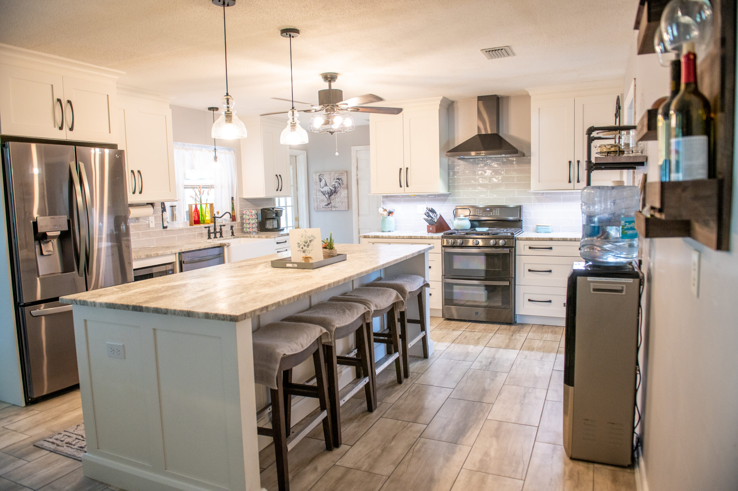 Full kitchen cabinetry made of hickory painted in the color snow with deep shaker doors