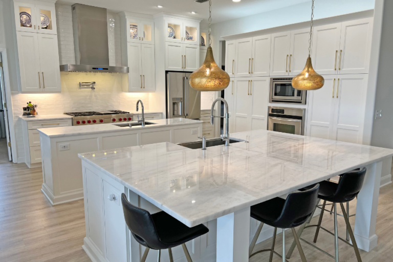 Finished maple kitchen cabinetry and island featuring portland doors in the color snow