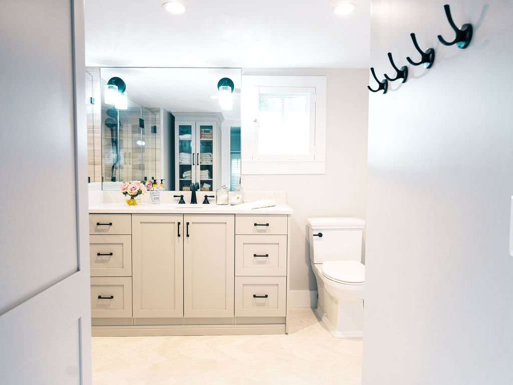 Bathroom vanity cabinetry made of maple painted with the finish snow featuring simple shaker doors