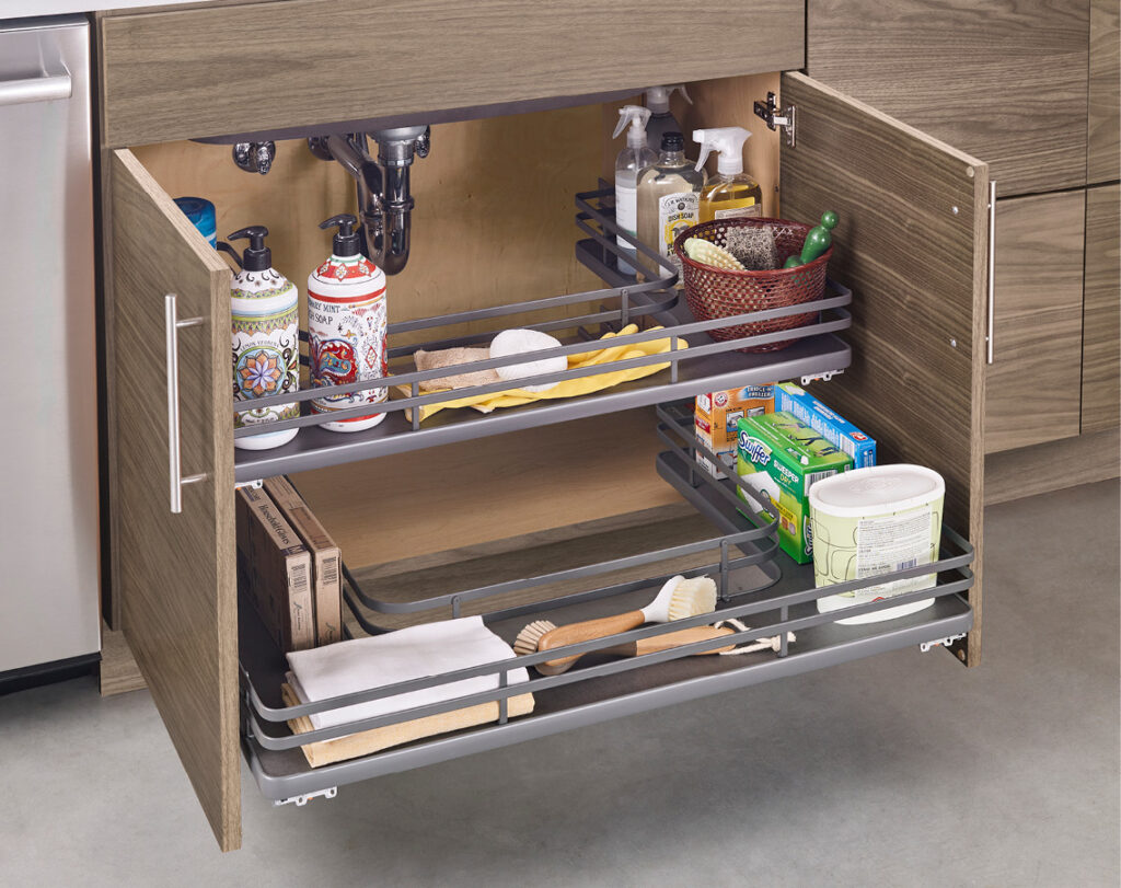 Undersink pullout drawers made of metal with metal railing. Drawers are cut into U shape so they can fit around kitchen sink piping