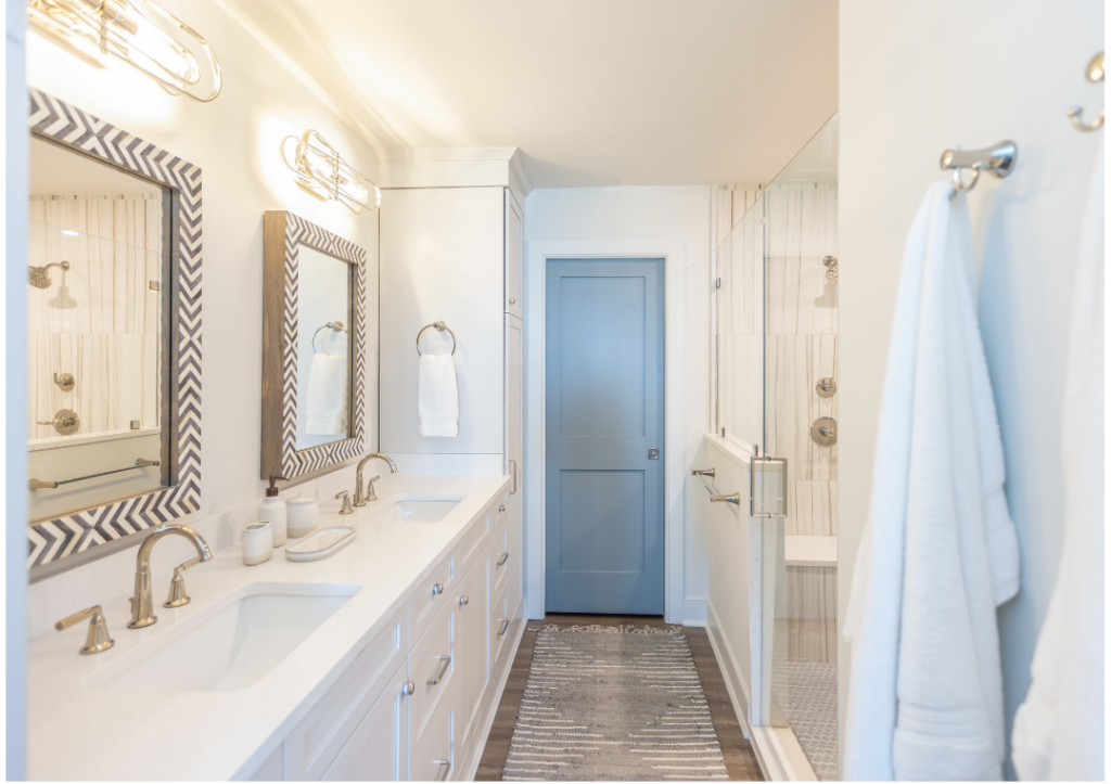 Bathroom cabinetry made of maple painted in the finish downy, with deep shaker doors.