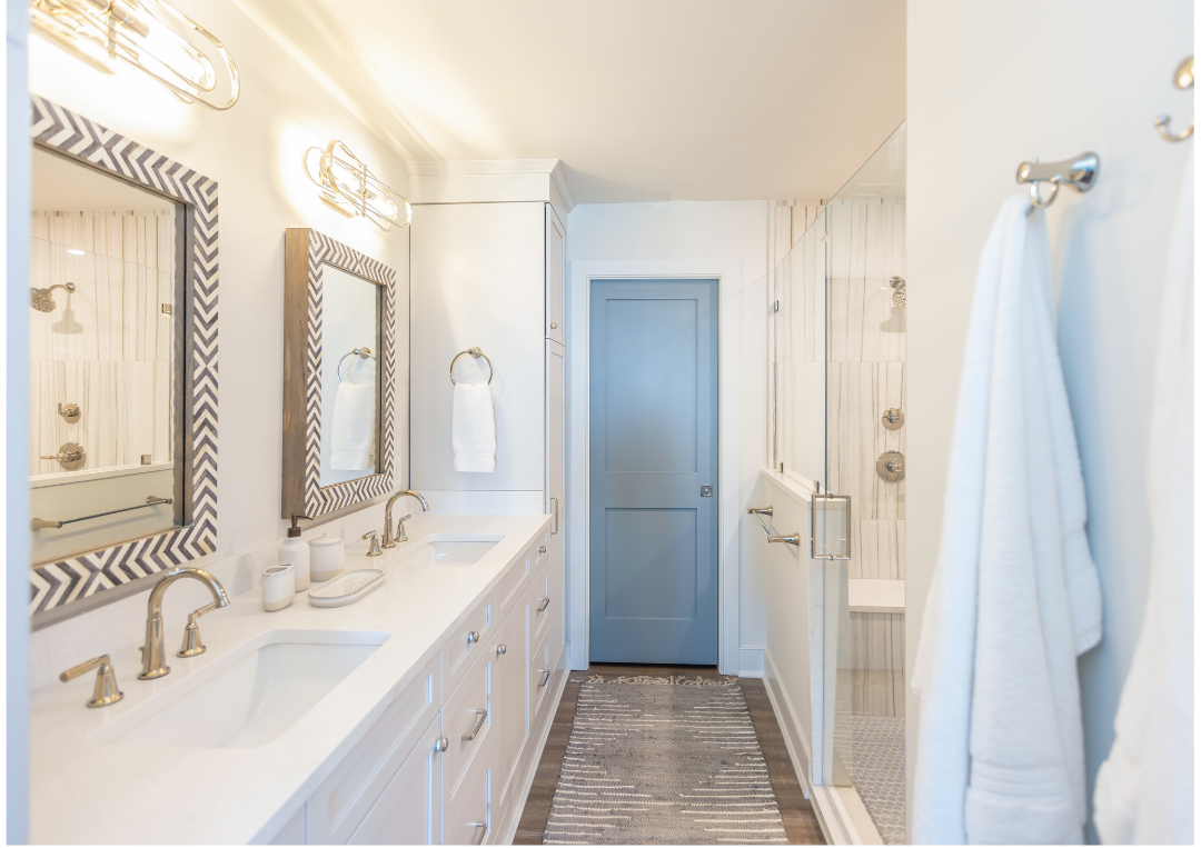 Bathroom cabinetry made of maple painted in the finish downy, with deep shaker doors.